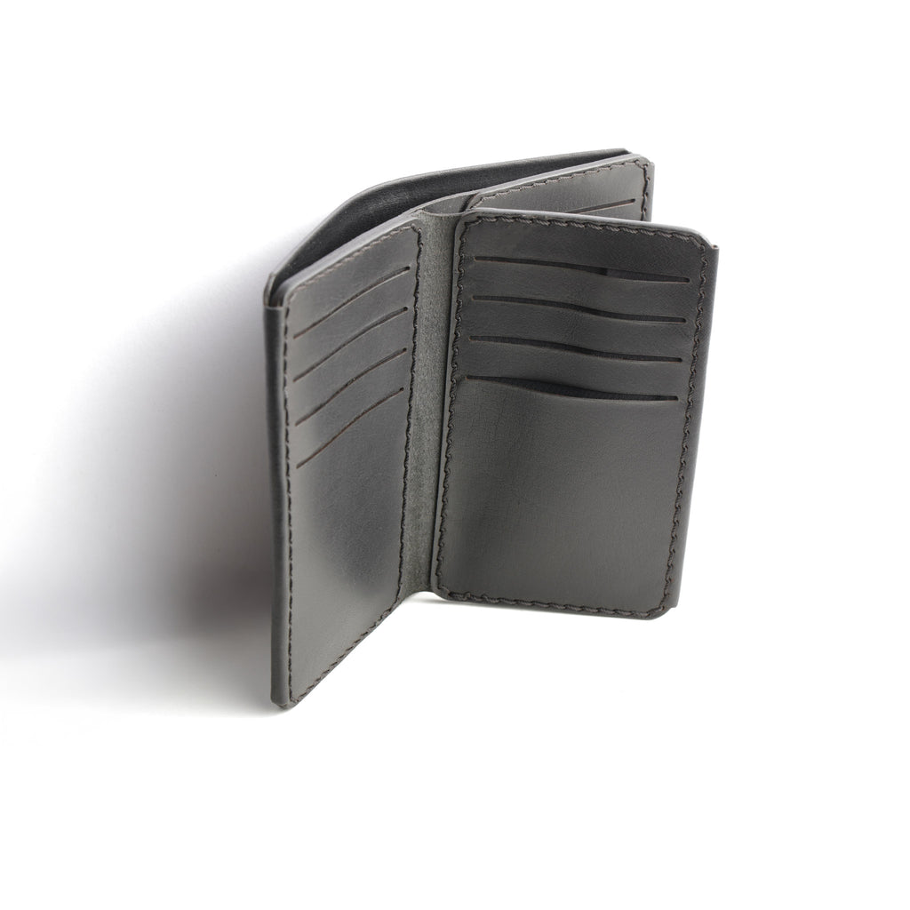 A detailed photo of The Maverick 2.2 Black Leather Wallet open, showing a cash compartment ready for use.

