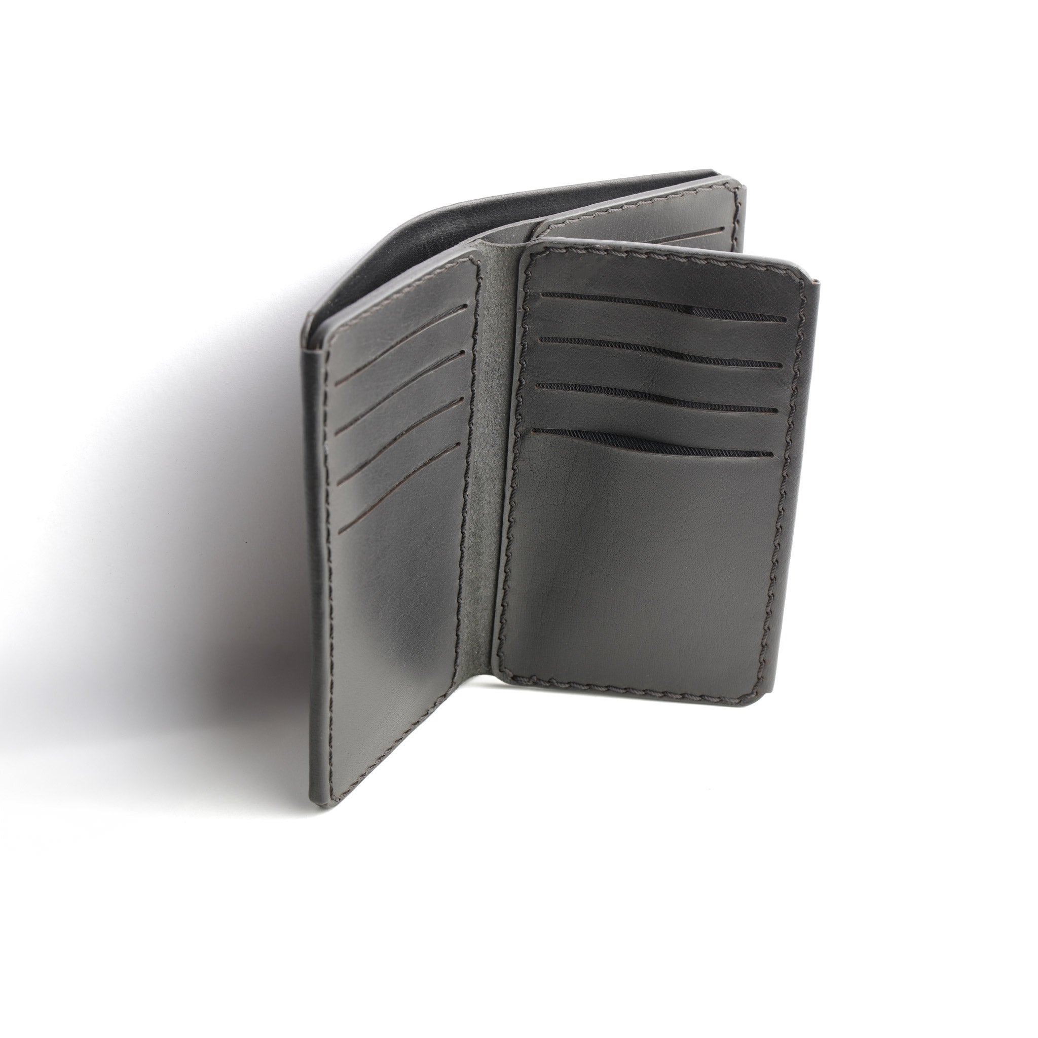 A detailed photo of The Maverick 2.2 Black Leather Wallet open, showing a cash compartment ready for use.

