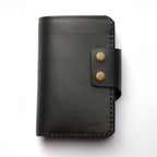 Black leather wallet with gold rivets on a white background maverick 2.2 black wallet, men's wallet, single color, luxury leather good