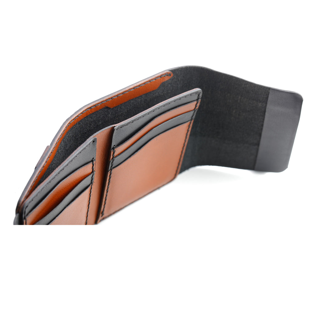 A top-down view of the Lockfold 1.0 Trifold Wallet, showcasing the black and glossy tan dual-tone leather.