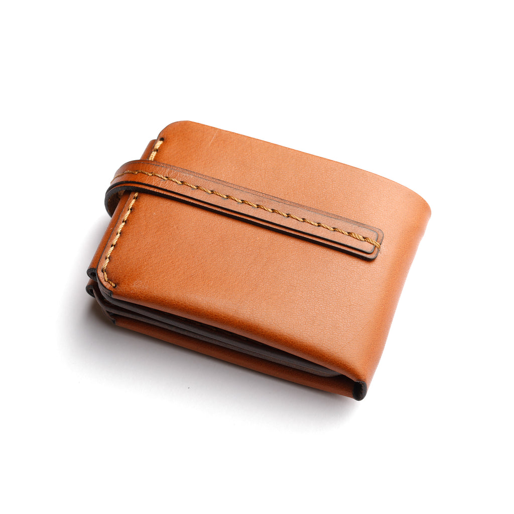 back side view of The Monarch 10-Slot Traveler trifold wallet, premium full-grain leather, stylish tanned accessory