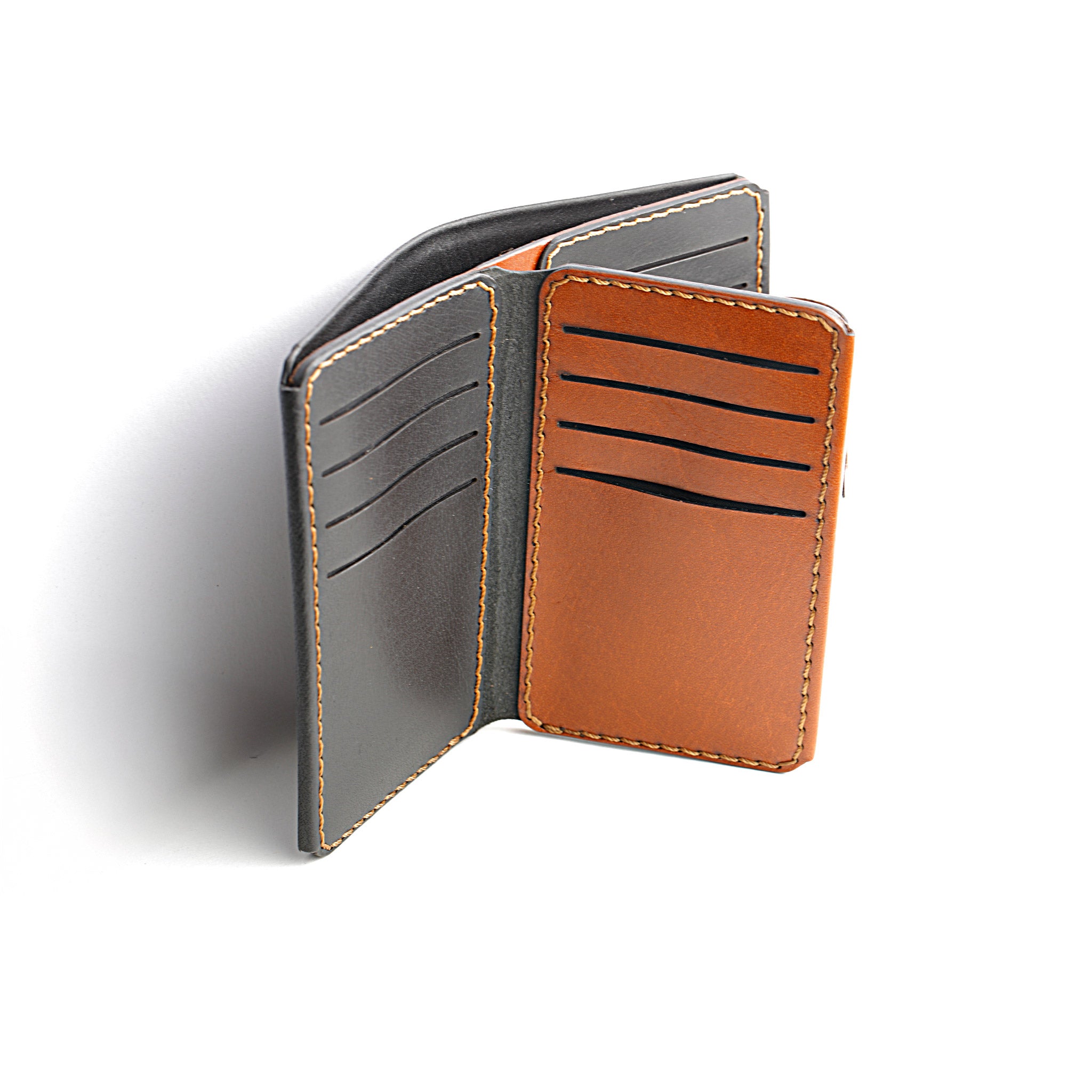 A detailed photo of The Maverick 2.1 Dual-Tone Wallet open, showing a cash compartment ready for use.

